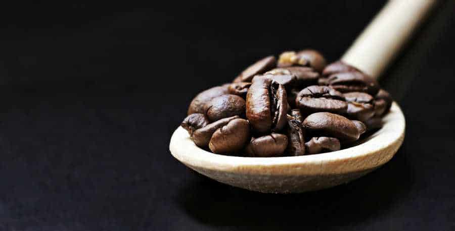 Coffee Beans displayed on a wooden spoon