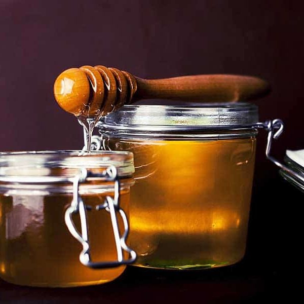 A couple jars full of honey.