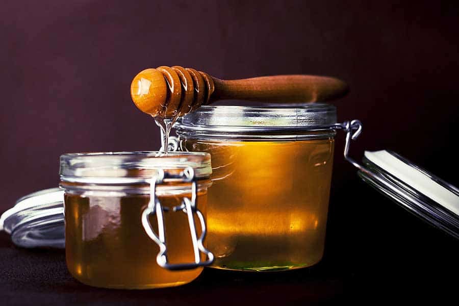 A couple jars full of honey.