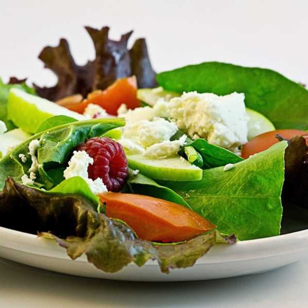 Fresh bowl of salad on white table