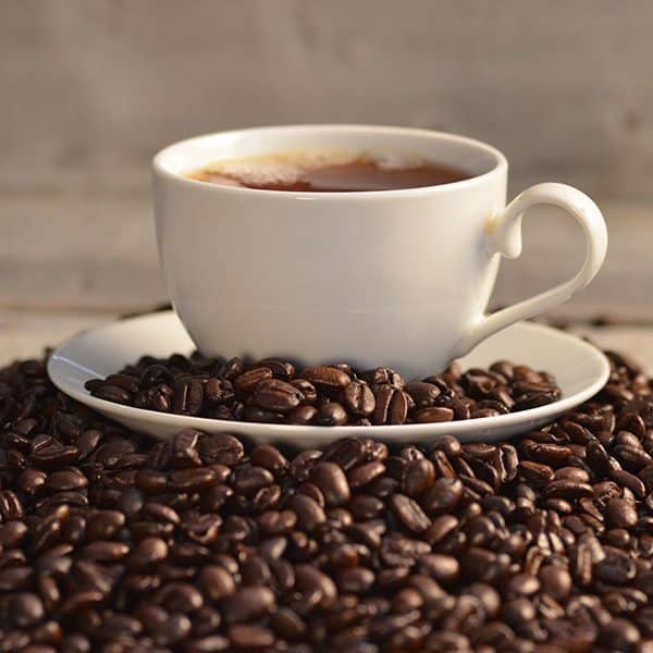 Coffee beans around a coffee cup in one of the Mochas & Javas coffee shops in Frisco TX.