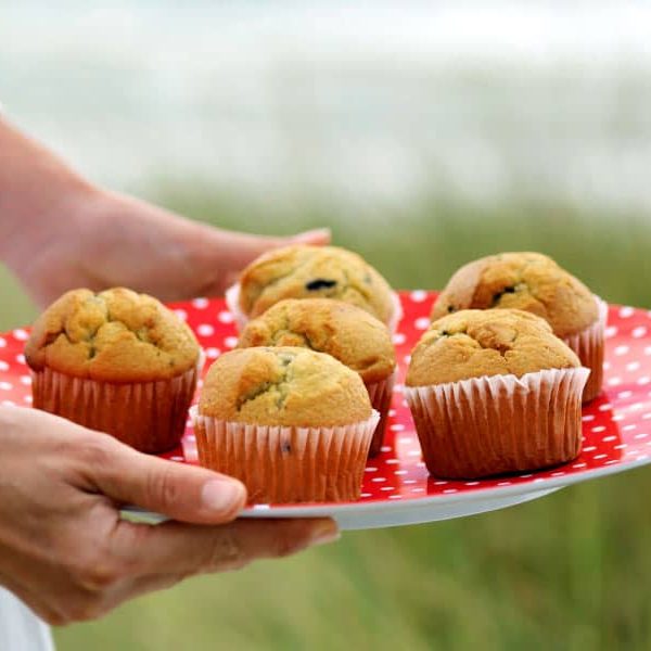 Woman Holding a Plate of Muffins