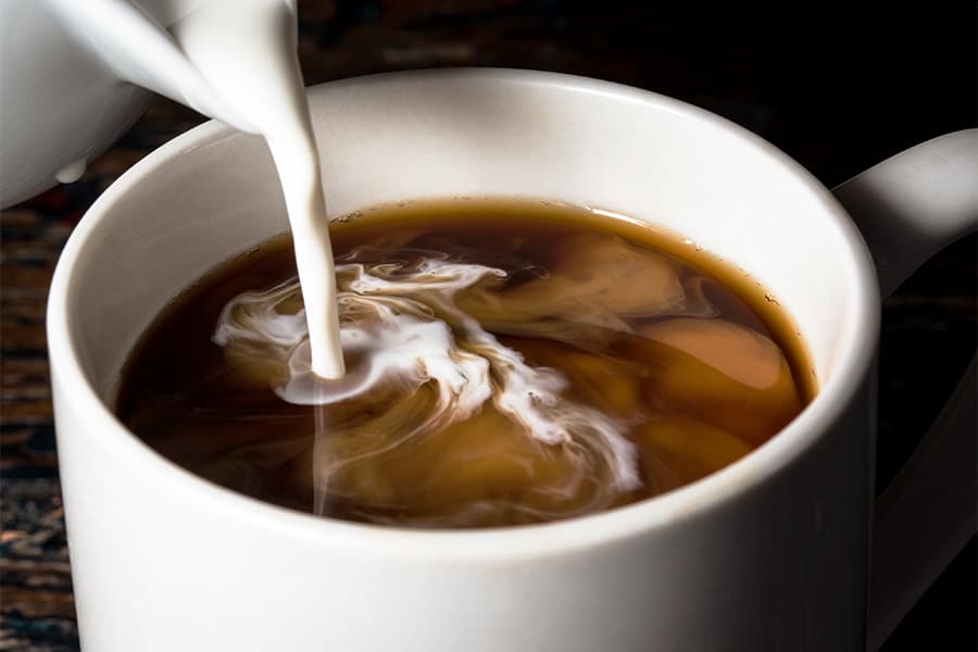 Creamer being poured in coffee