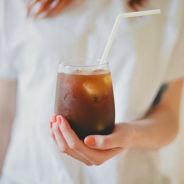 Woman holding iced coffee in San Marcos TX