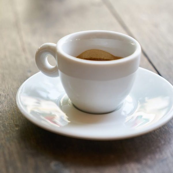 White cup of espresso on saucer