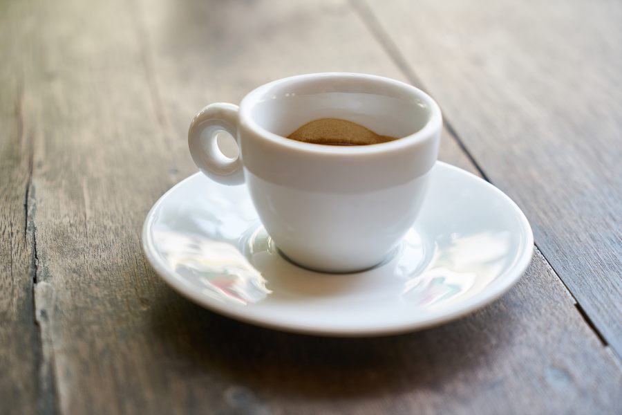 White cup of espresso on saucer