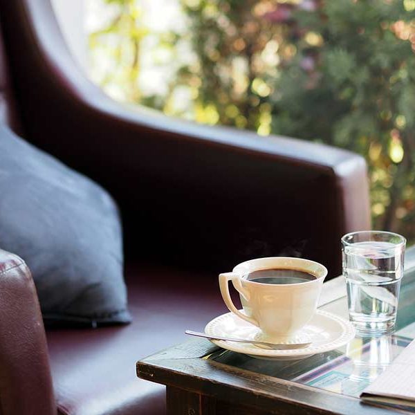 Cozy chair near an end table with a cup of coffee