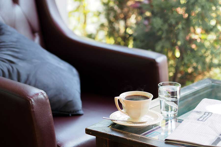 Cozy chair near an end table with a cup of coffee