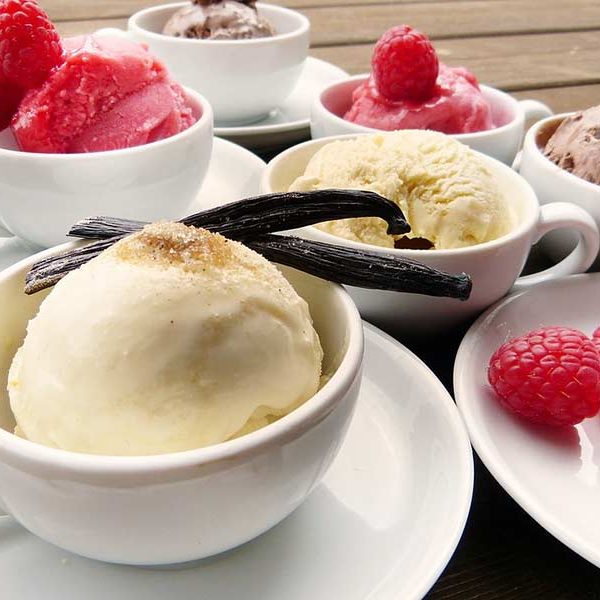 bowls of vanilla ice cream decorated with vanilla bean pods