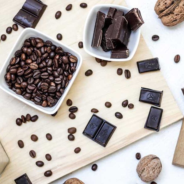 Coffee beans and chocolate bars on a cutting board