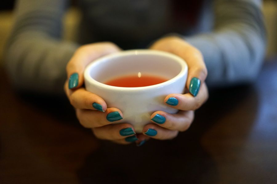 Cup of rooibos tea held in someone's hands