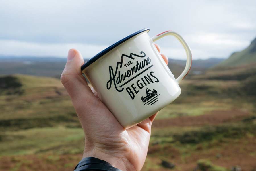 Coffee mug with the text "The Adventure Begins"