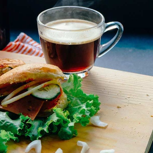 Cup of tea next to a veggie sandwich at Coffee Shops that have Breakfast & smoothies in San Marcos & Frisco, Tx