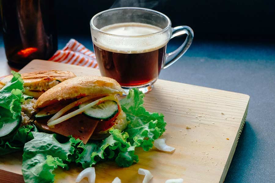 Cup of tea next to a veggie sandwich at Coffee Shops that have Breakfast & smoothies in San Marcos & Frisco, Tx