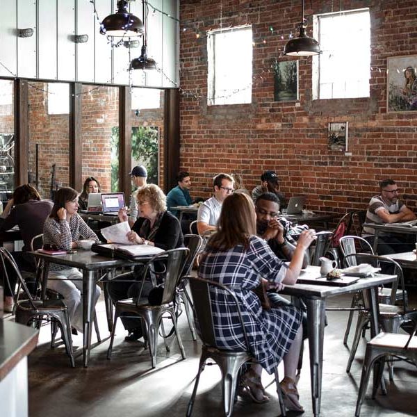 Interior photo of a bustling coffee shops in Frisco Tx with art hanging on the walls