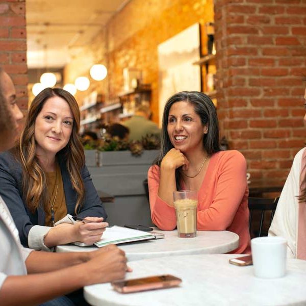 Guests chatting in a coffee shop in San Marcos at a networking event