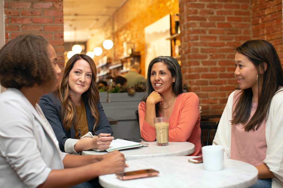 Guests chatting in a coffee shop in San Marcos at a networking event