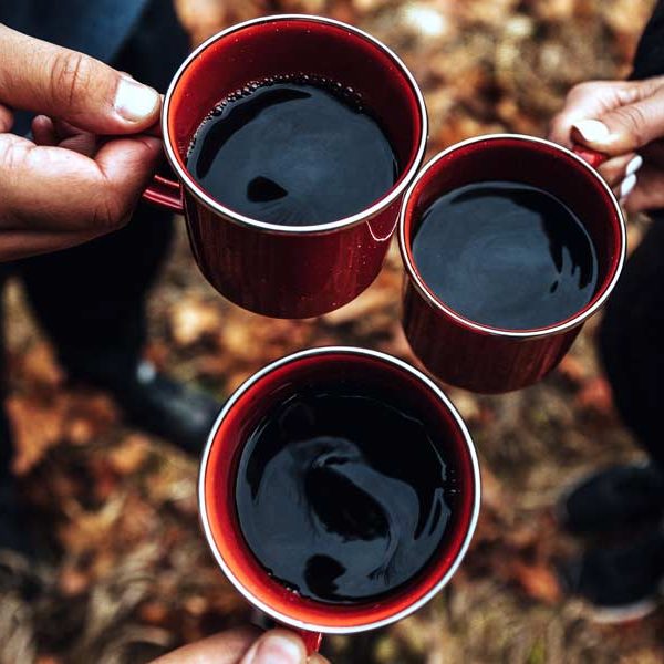 3 people toasting with coffee mugs at a coffee shop or shops in frisco tx