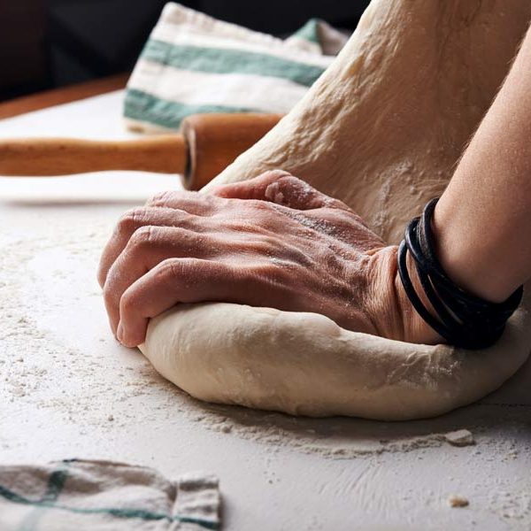 Hands kneading bread dough