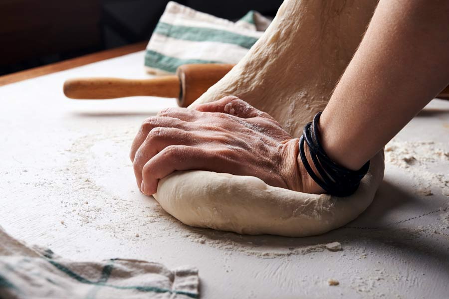 Hands kneading bread dough