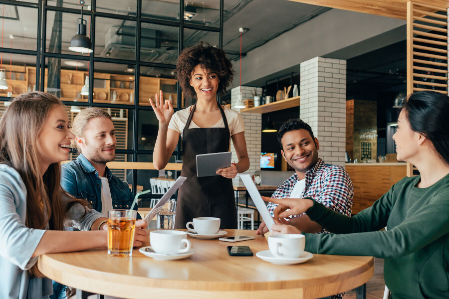 A group of friends socializing over coffee at a coffee shop.