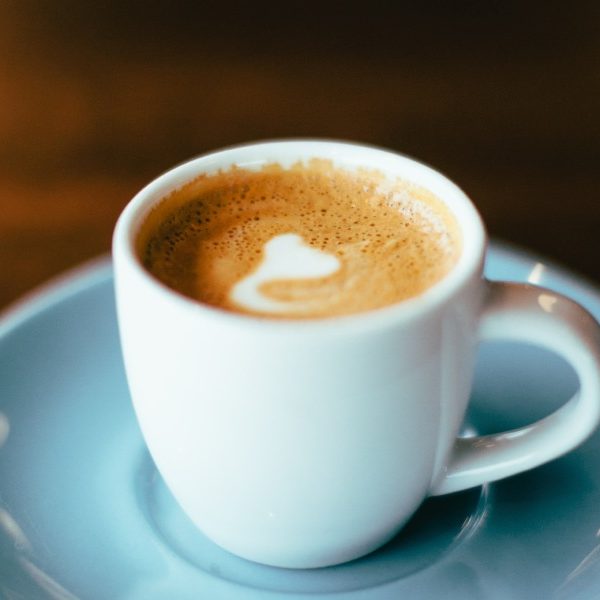 light blue coffee cup and saucer with cappuchino in it - Coffee Drive Thru Shops in Frisco, Tx