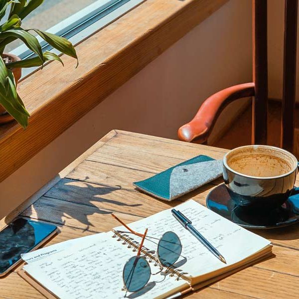 Cozy table with a notebook at a coffee shop - Coffee Shops in San Marcos & Frisco, TX that sells sandwiches