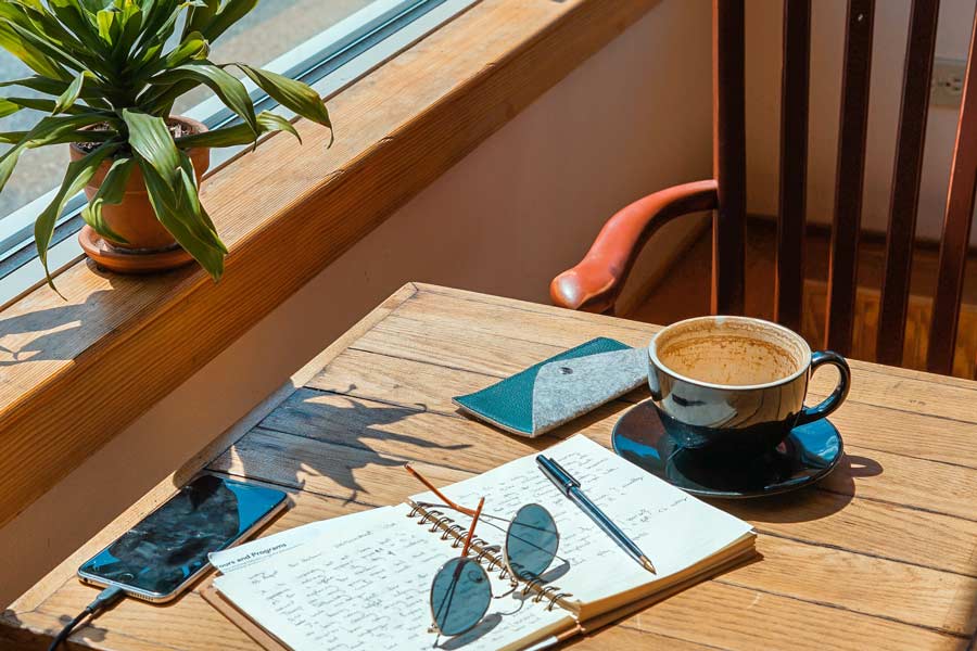 Cozy table with a notebook at a coffee shop - Coffee Shops in San Marcos & Frisco, TX that sells sandwiches