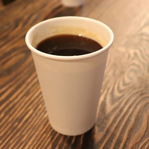 Close up of a paper coffee cup on a table.