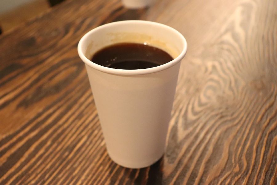 Close up of a paper coffee cup on a table.