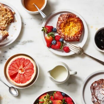Breakfast table with fruits, pastries, and San Marcos coffee being poured.