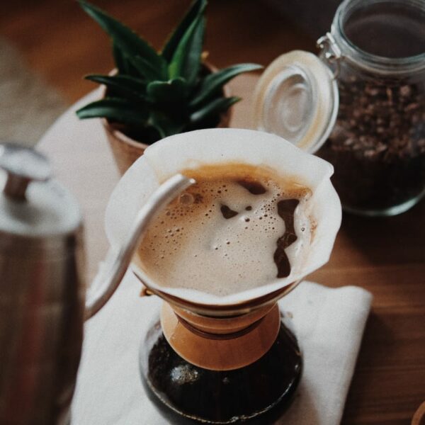 Pouring hot coffee in a cup