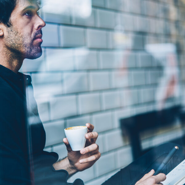 Picture of a man concentrated while drinking a cup of espresso