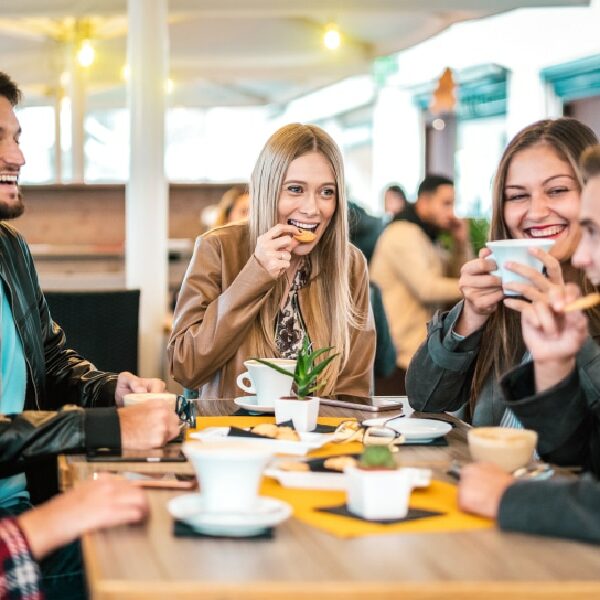 Friends enjoying coffee and treats in Frisco, laughing and having a great time together