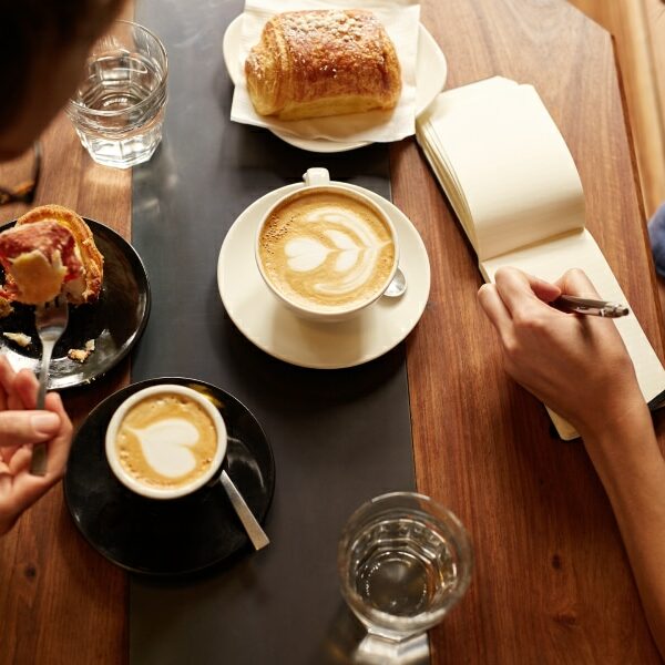 Group of friends enjoying a casual planning session over San Marcos coffee and treats