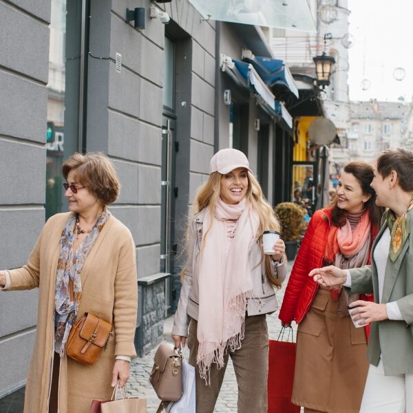 A group of beautiful women taking an afternoon coffee while walking through the avenue