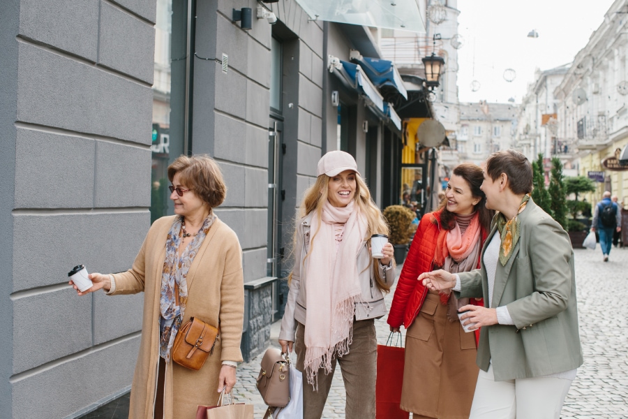 A group of beautiful women taking an afternoon coffee while walking through the avenue