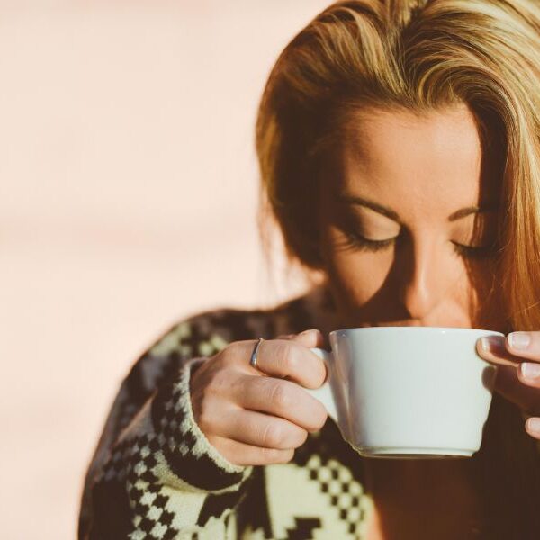 A woman drinking a cup of coffee.